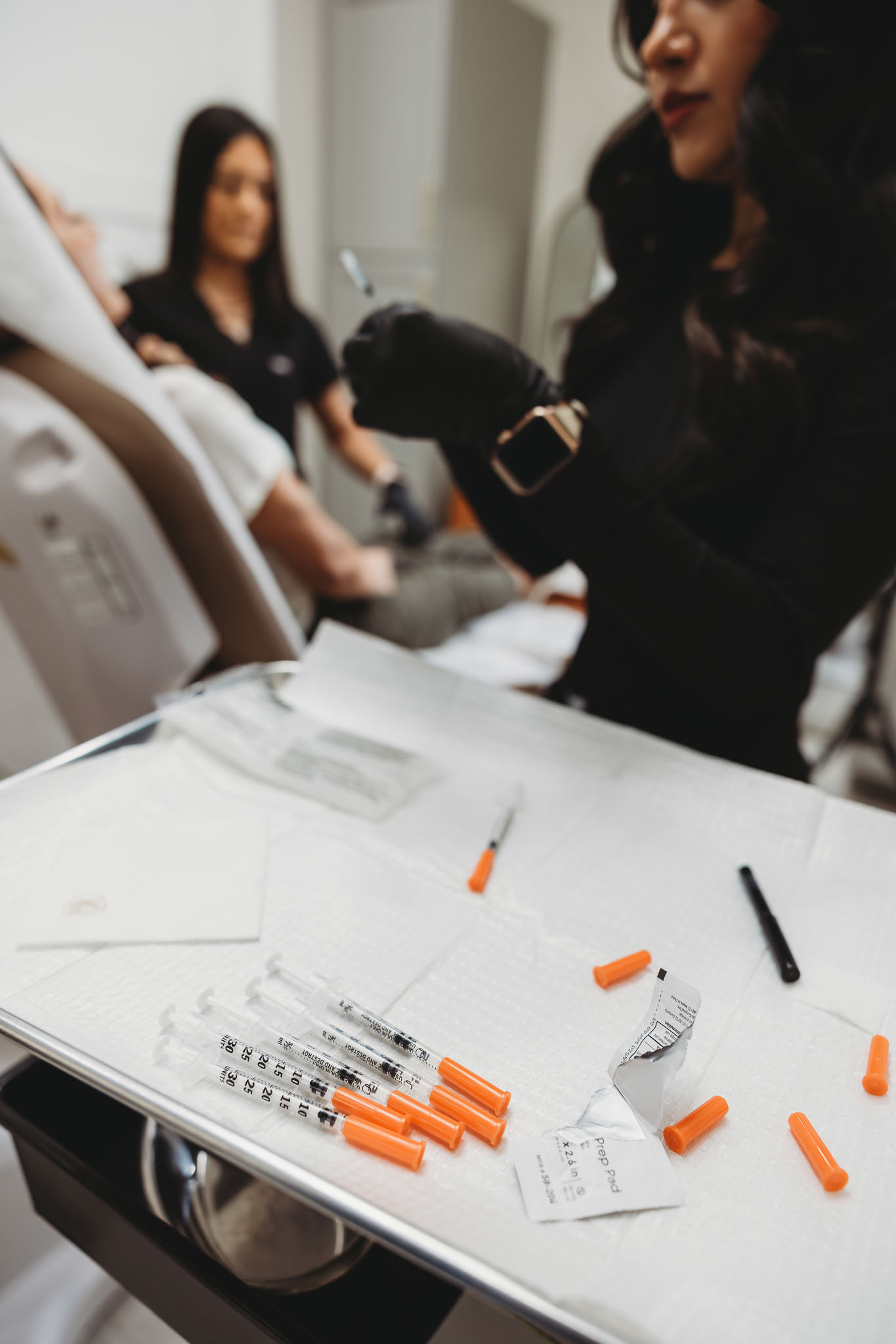 Multiple medical syringes or injectable treatment tools arranged neatly on a white surface.
