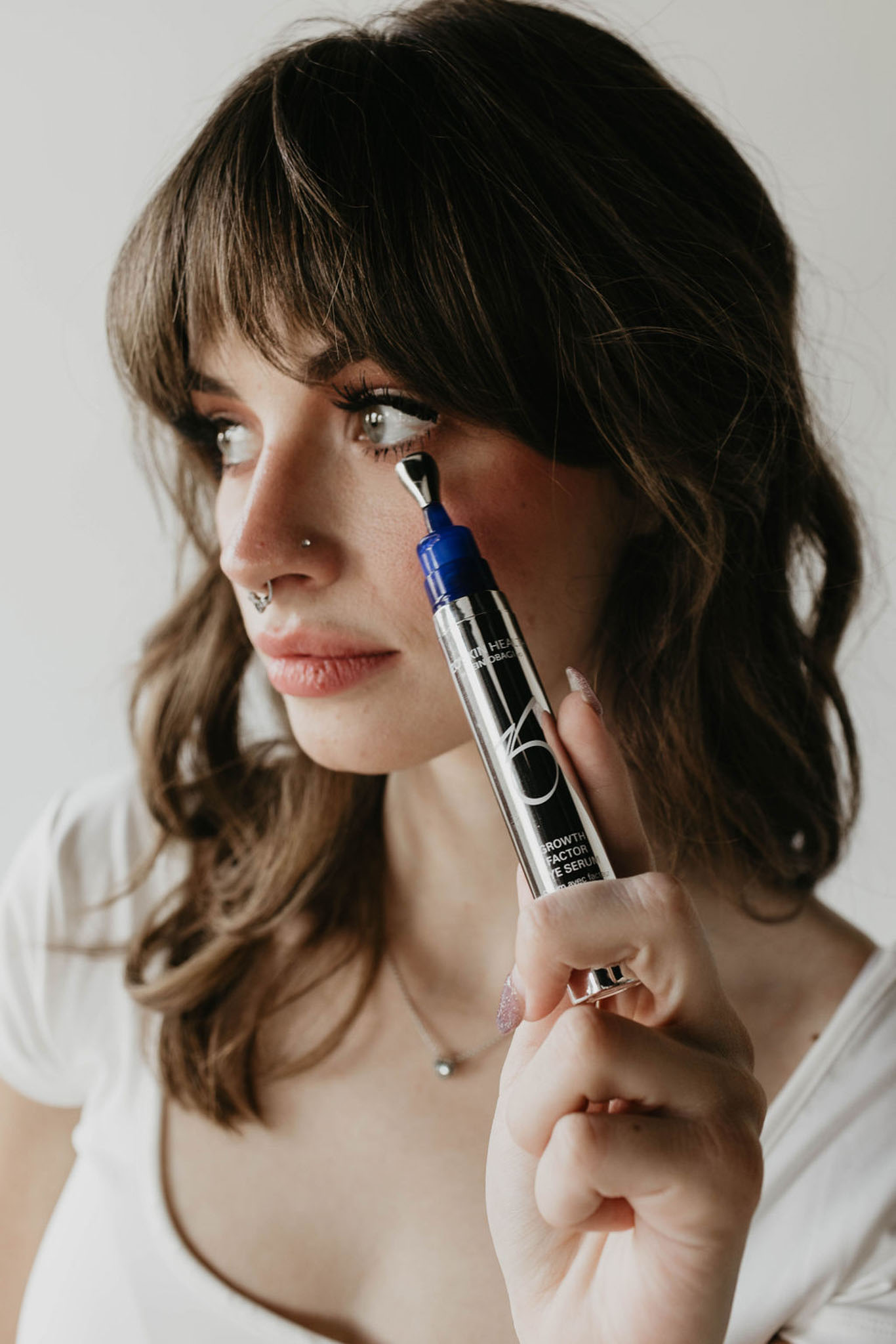 Applying Zo growth factor eye serum from Zo skincare products.