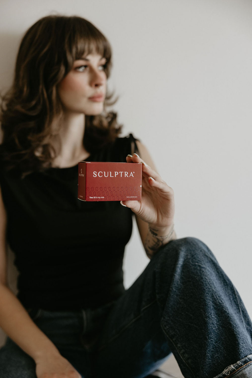 TBL Team member holding a box of Sculptra